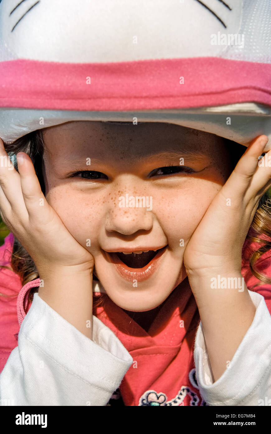 Smiling five year old girl with bike safety helmet. Stock Photo