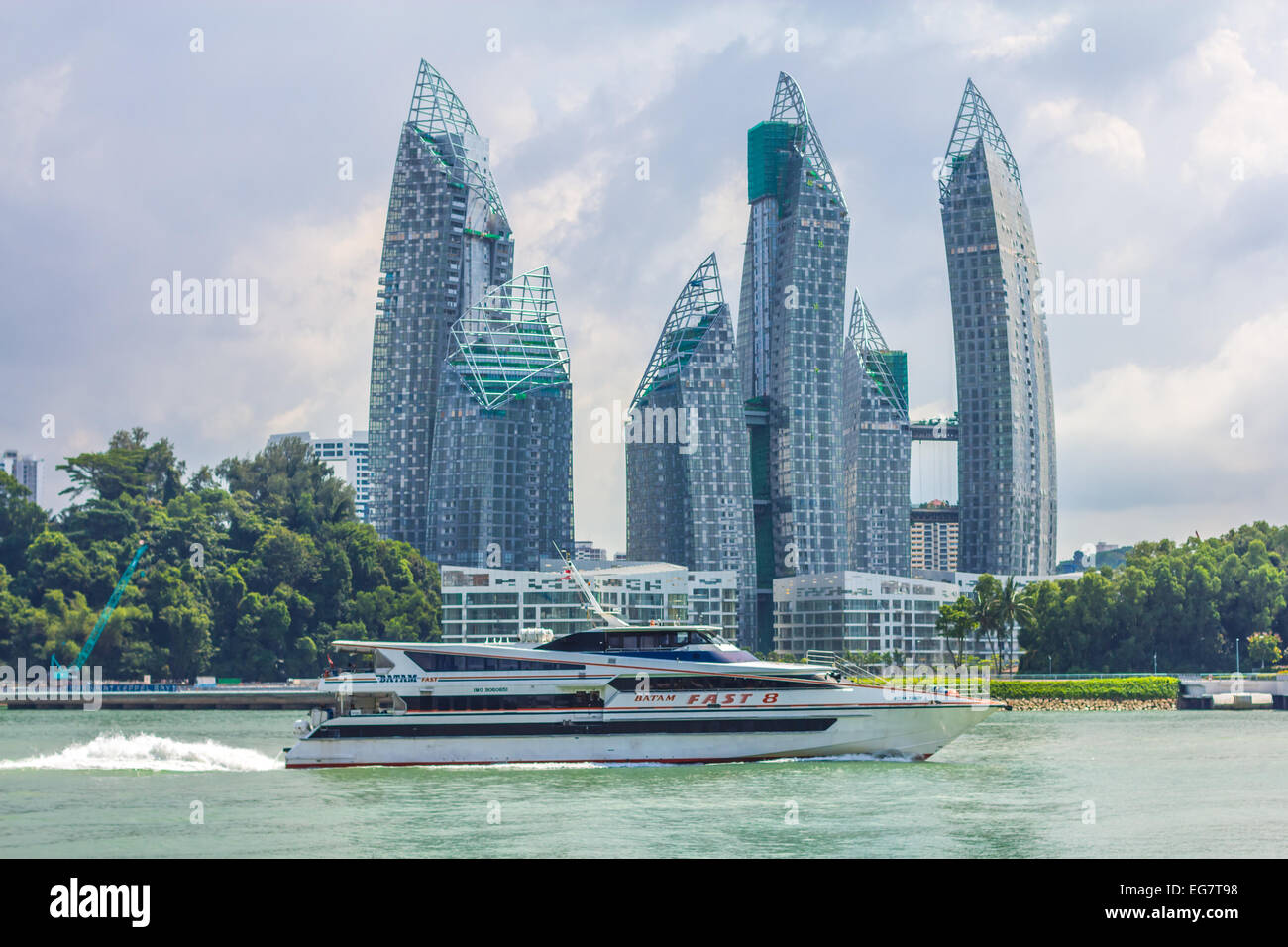 A modern luxury motor boat passes modern singapore skyscrapers, Stock Photo