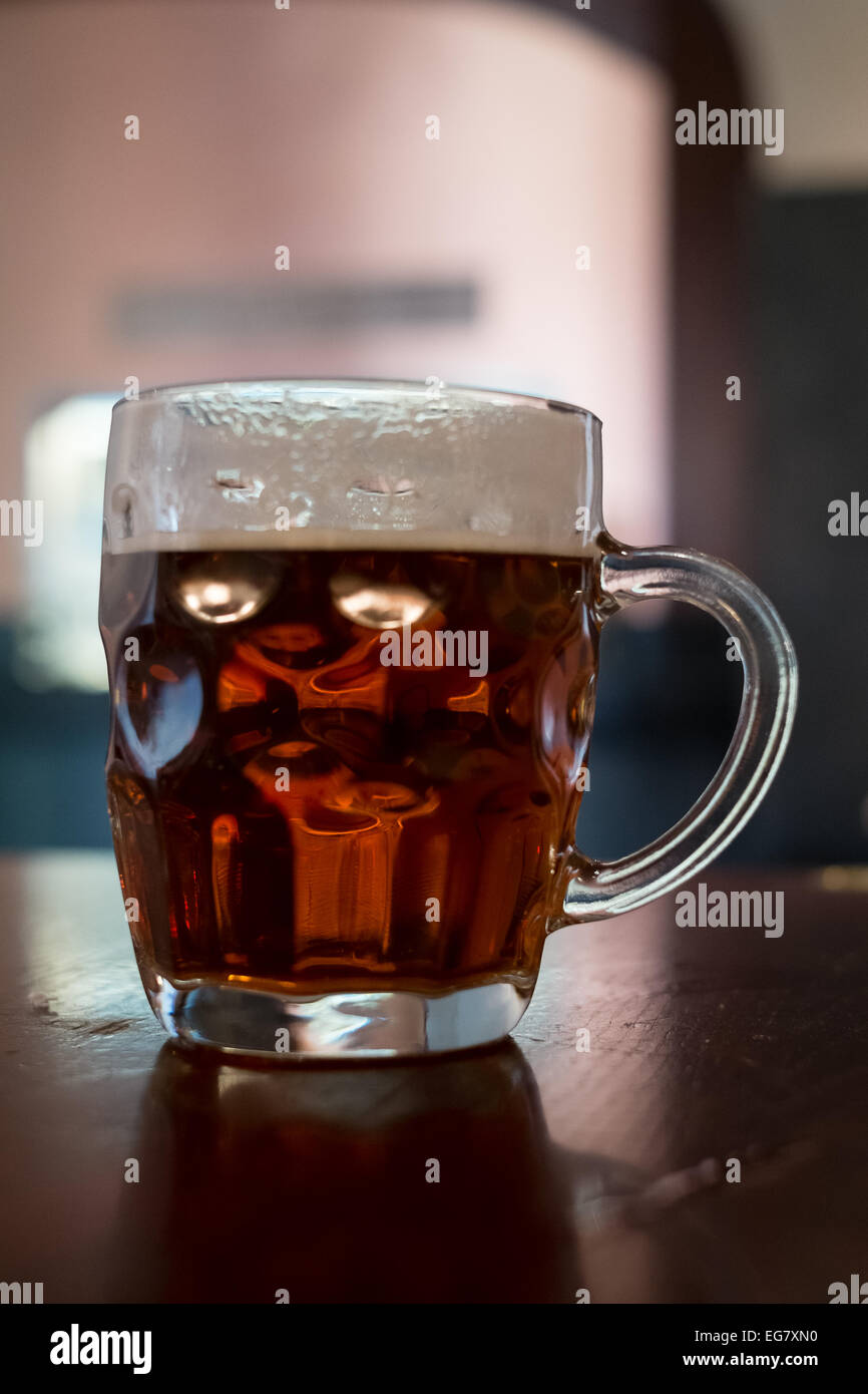 Pint of beer in a traditional dimpled glass tankard Stock Photo