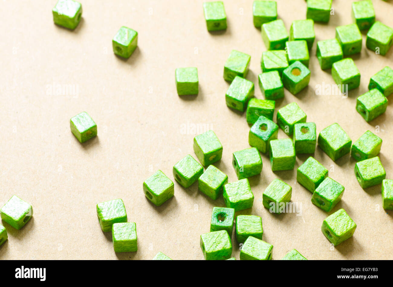 green wooden cubic beads on paper background Stock Photo