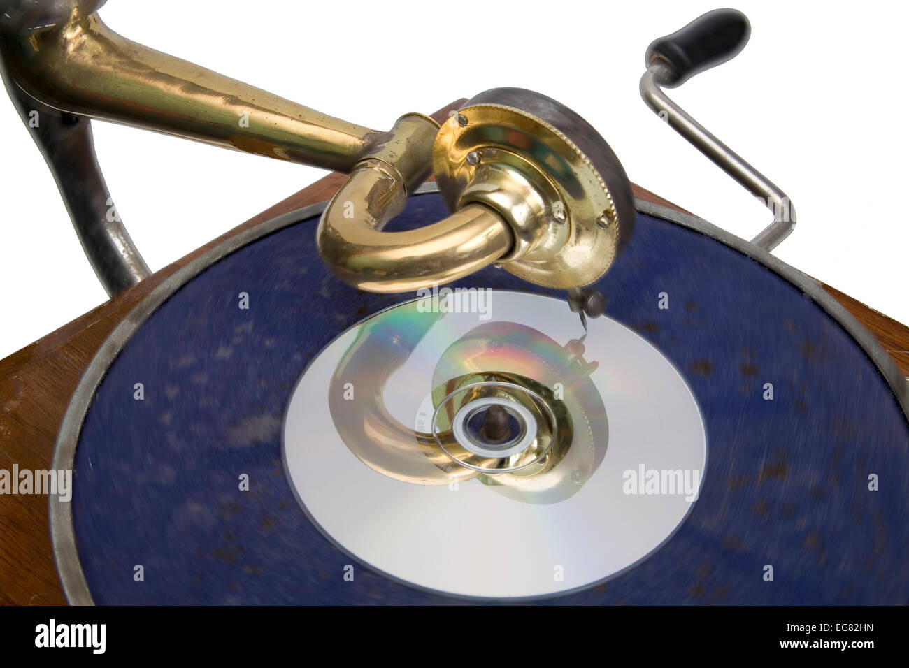 A CD sits on the turntable of a vintage gramophone /record player. Illustration of technological