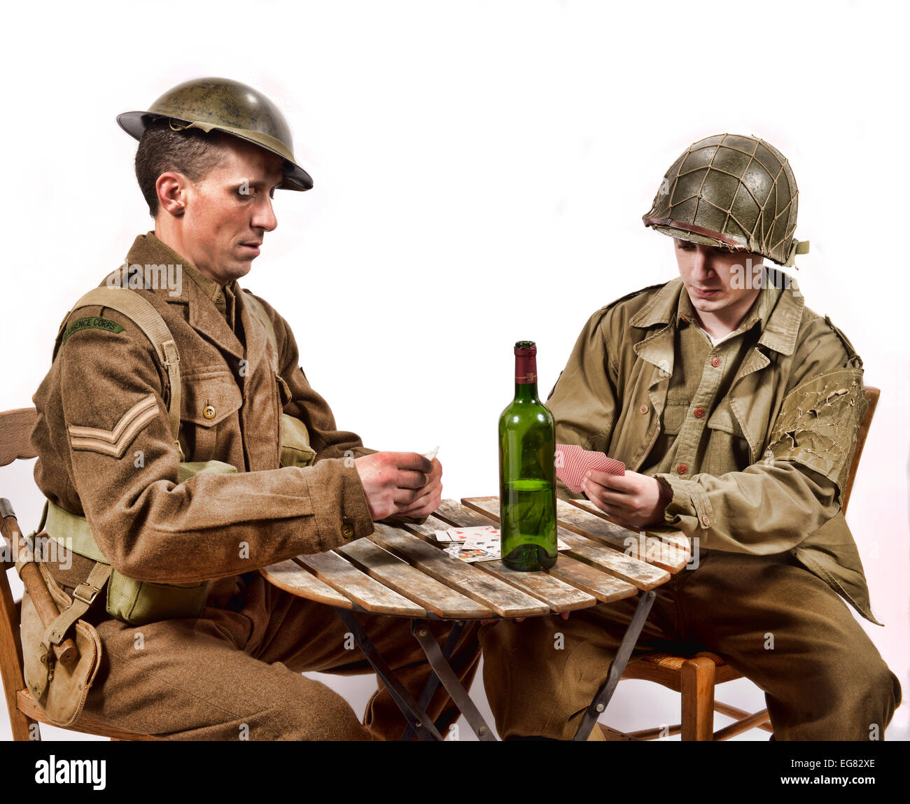 an English soldier and an American soldier playing cards on small table