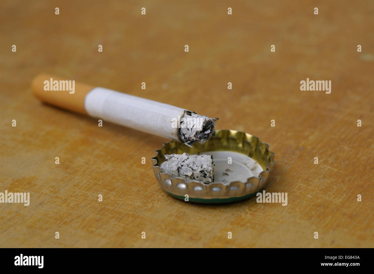 Cigarette ash on crown cap Stock Photo