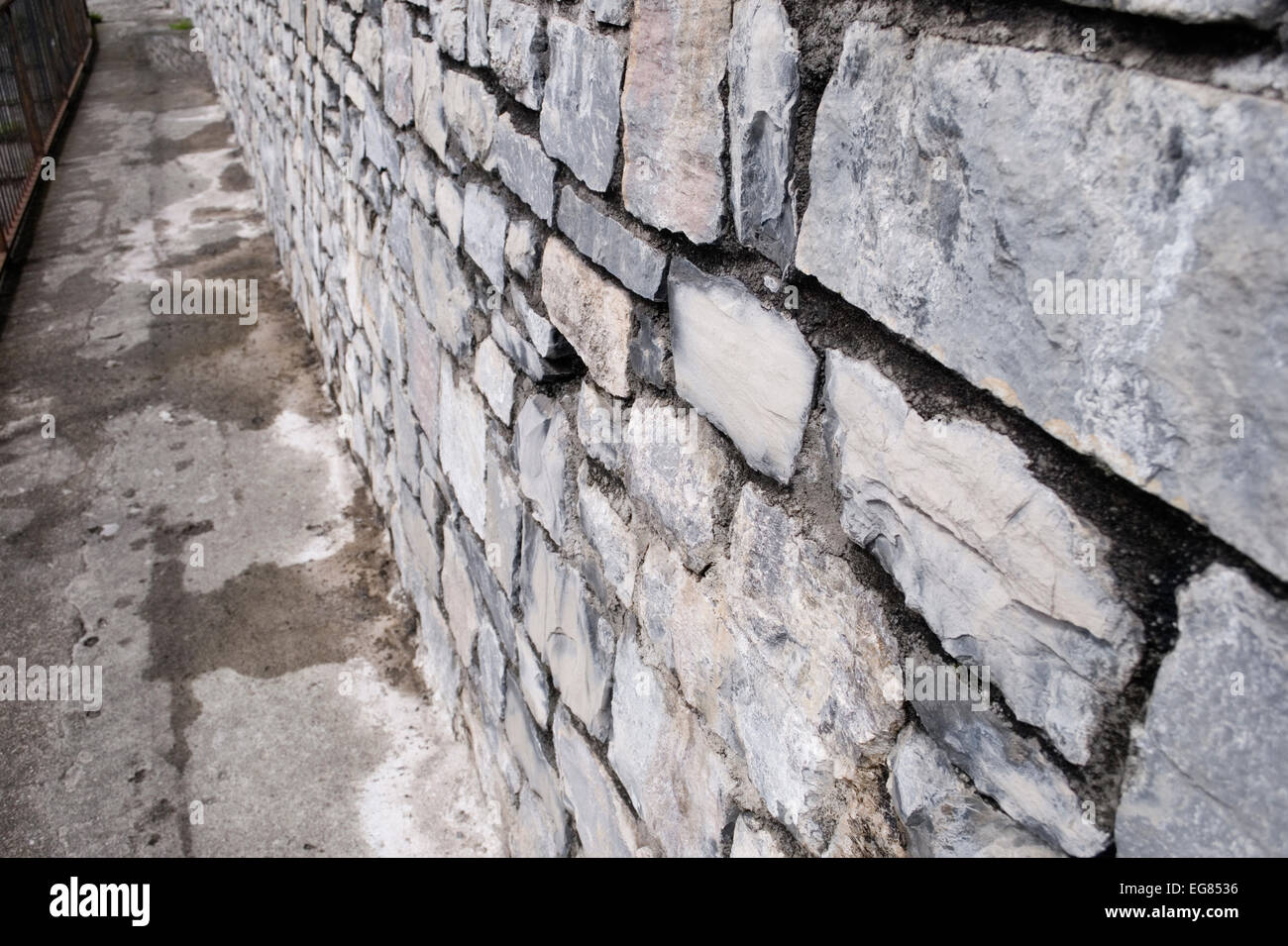 Old stone wall along a narrow passage Stock Photo - Alamy