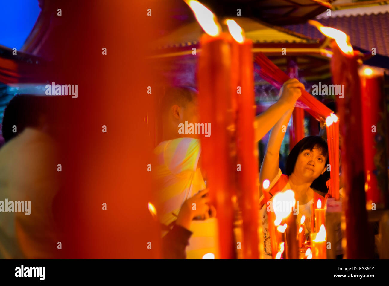 People burn incense sticks on Chinese New Year's Eve at Jin De Yuan