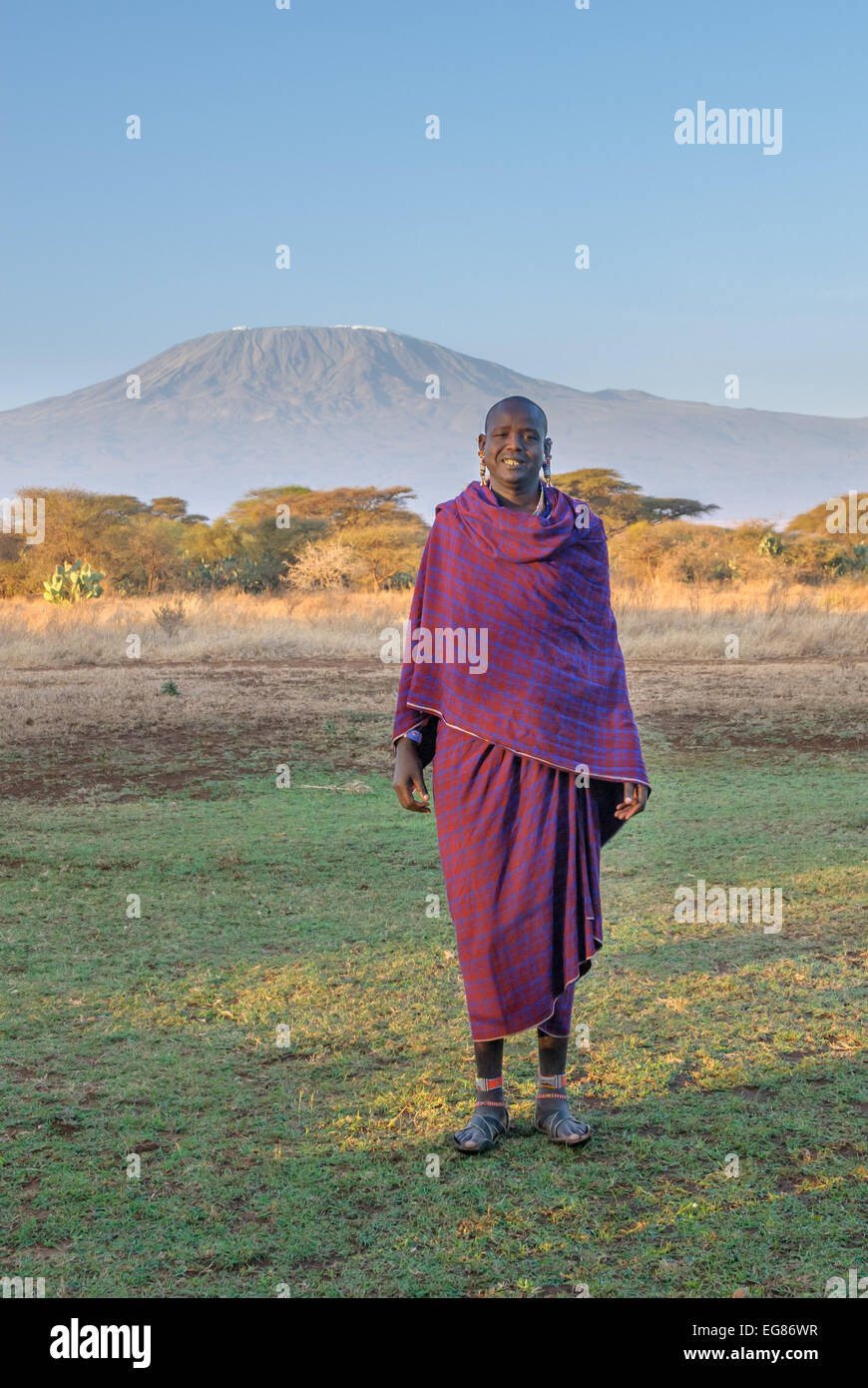 AMBOSELI, KENYA - September, 20: Young Masai man and Kilimanjaro mountain at backdrop on September, 20, 2008 in Amboseli Nationa Stock Photo