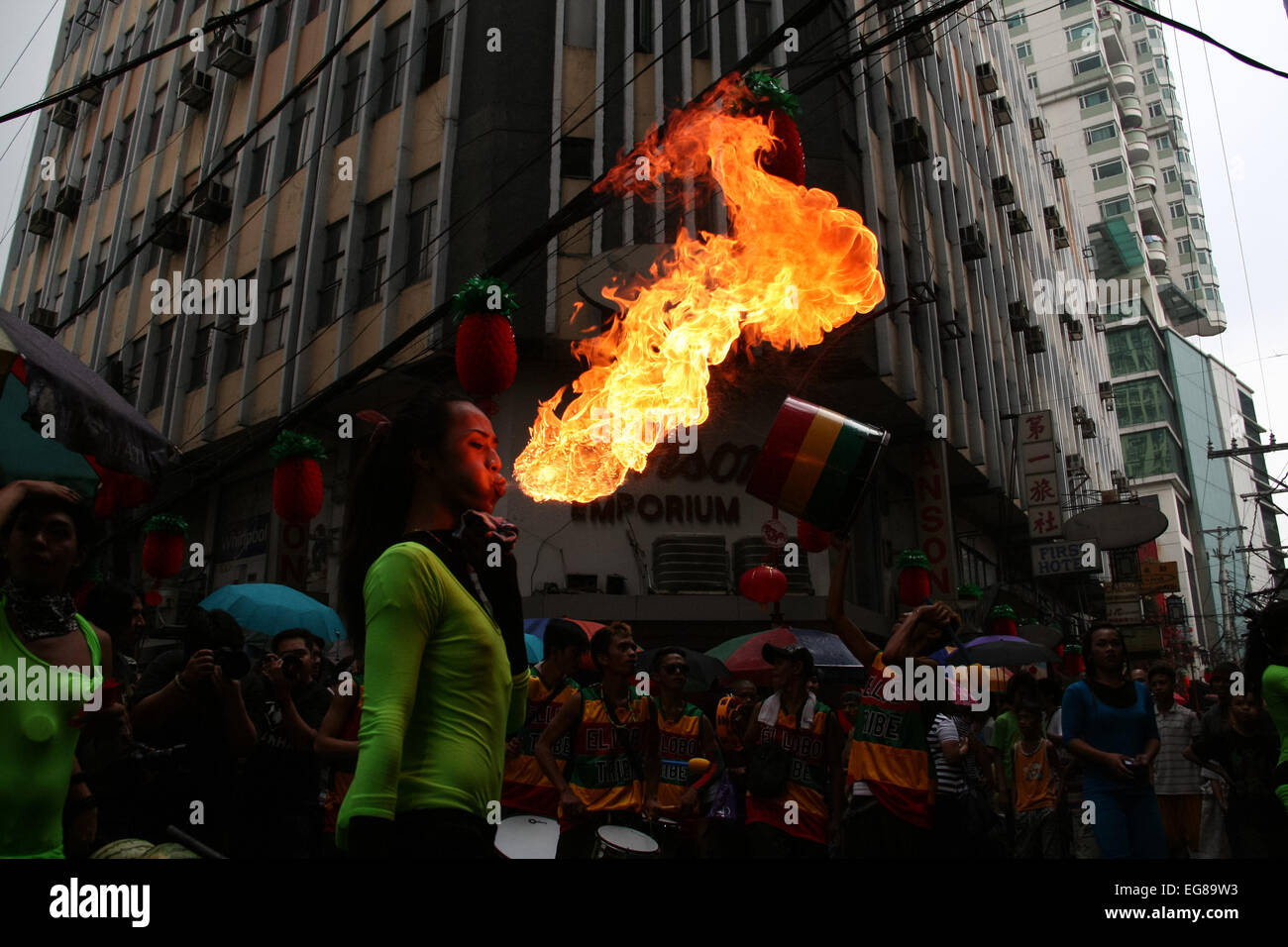 A fire eater blows fire to the watching crowd along Ongpin street in Binondo, Manila. Thousands of people joined in the celebration of the Lunar New Year in Binondo, Manila. The Filipino-Chinese community, in the oldest china town in the world, welcomed the year of the wooden sheep with dragon and lion dances. © Gerard Seguia/Pacific Press/Alamy Live News Stock Photo