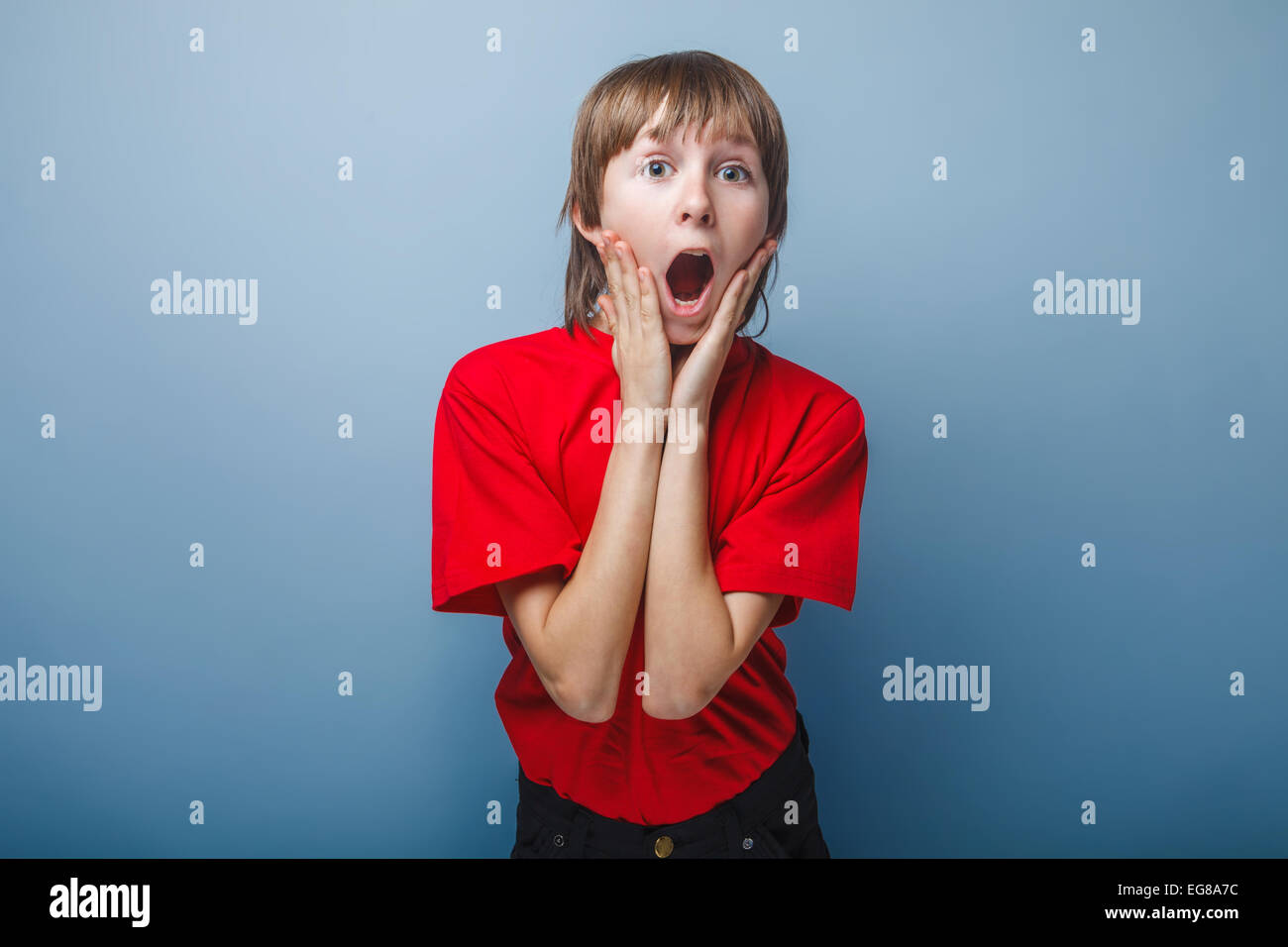 boy teenager European appearance in a red shirt holding hands on Stock Photo