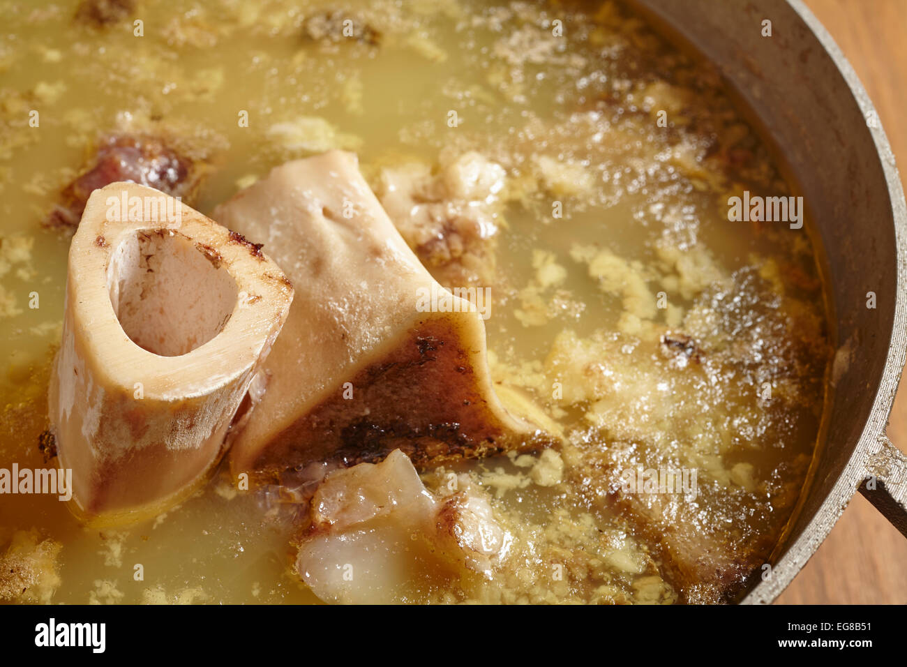 Pot of partially cooked beef bone broth Stock Photo