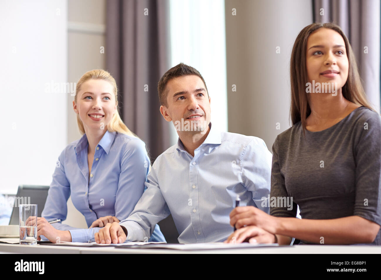 group of smiling businesspeople meeting in office Stock Photo - Alamy