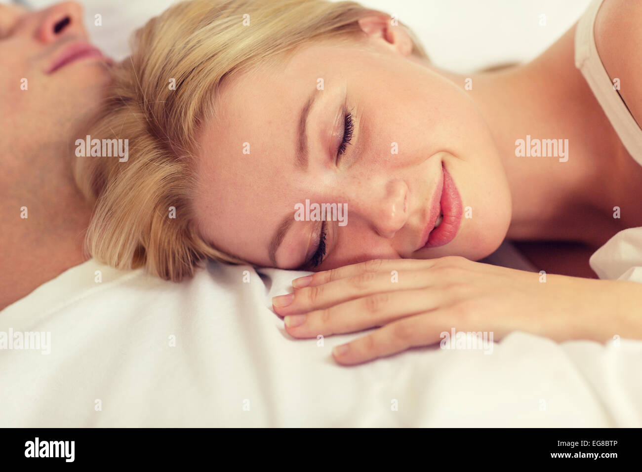 happy couple sleeping in bed Stock Photo - Alamy
