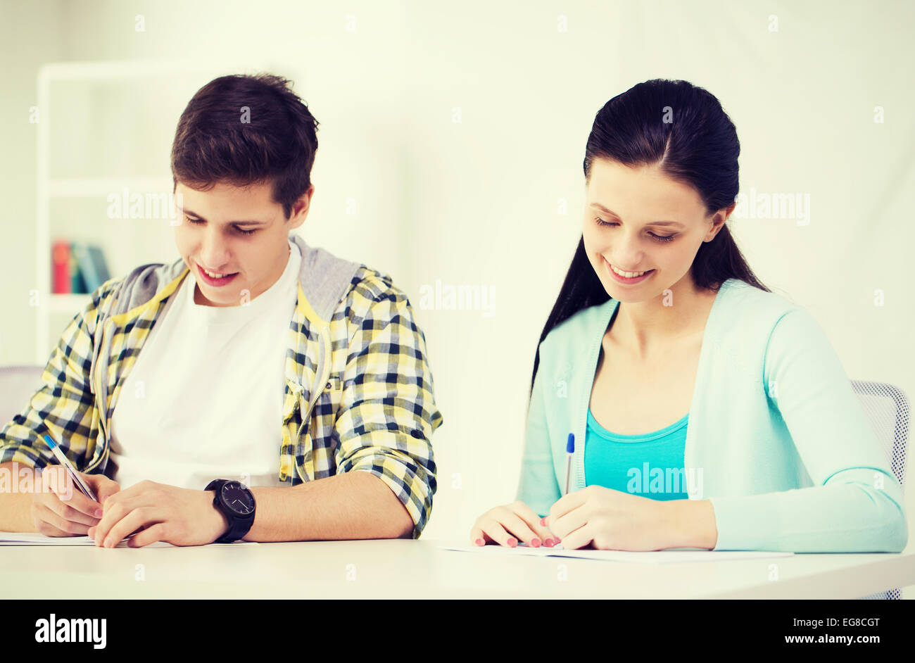smiling students with textbooks at school Stock Photo - Alamy