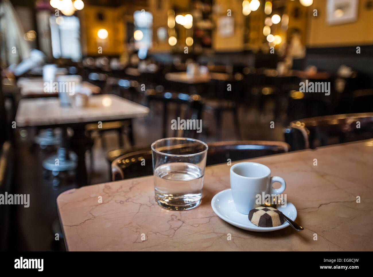 Trieste, Italy - A small cup of coffee, a chocolate biscuit and mineral  water at historical Caffe San Marco Stock Photo - Alamy