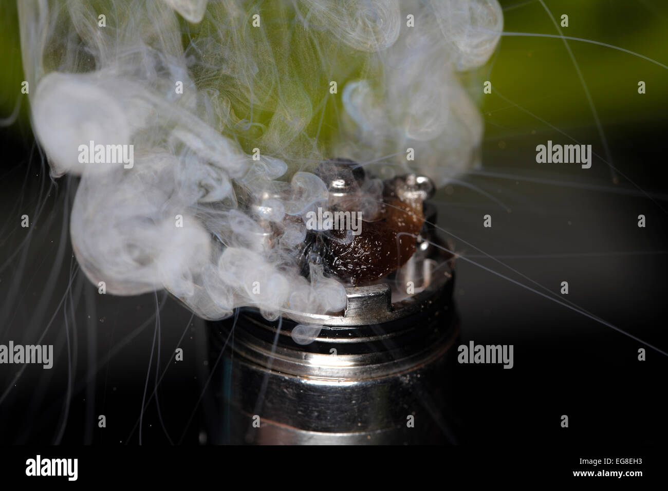 An electronic cigarette spews vapor. Stock Photo