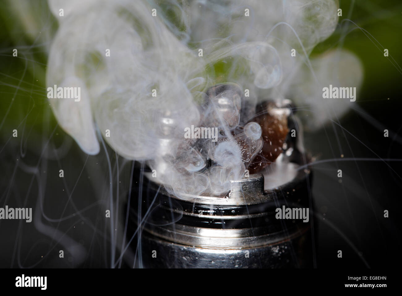 A mod-type e-cigarette spews out microscopic particles as well as vapors. Stock Photo