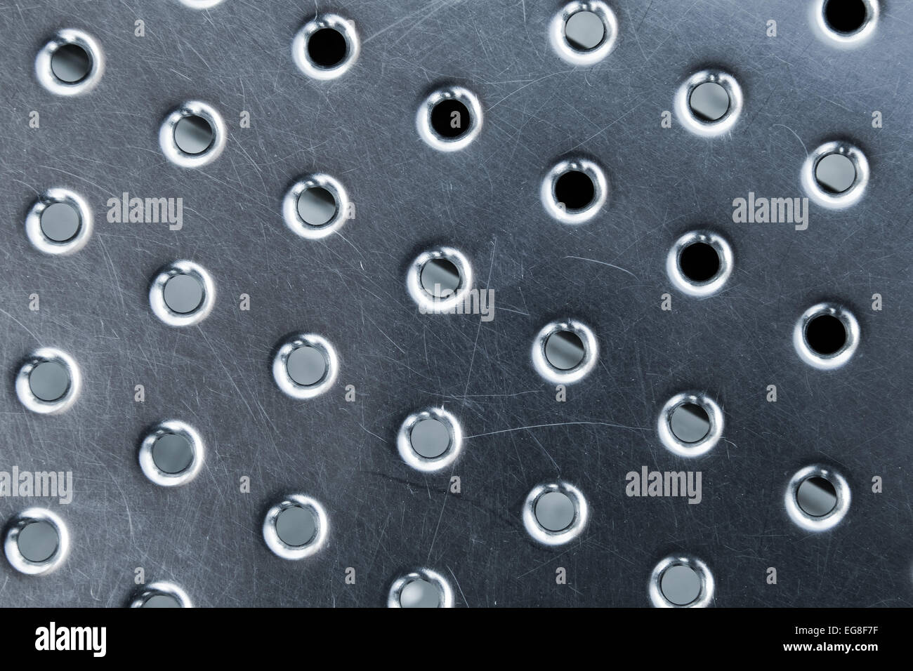Shining metal panel surface with round holes, abstract background texture Stock Photo