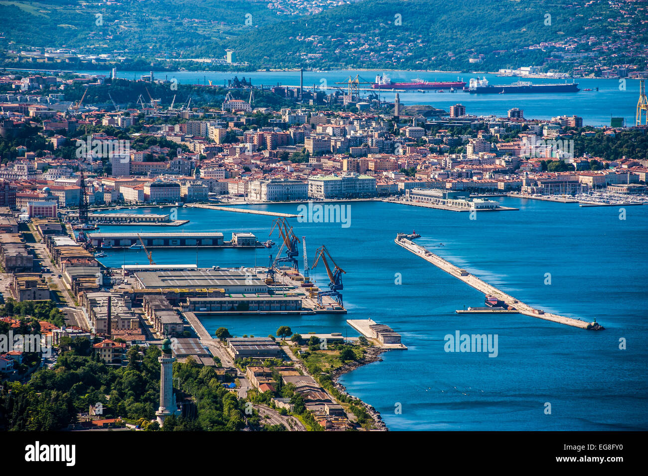 Trieste, Italy - A view of the city, the old port,the lighthouse and the Gulf of Trieste seen from a high vantage point. Stock Photo