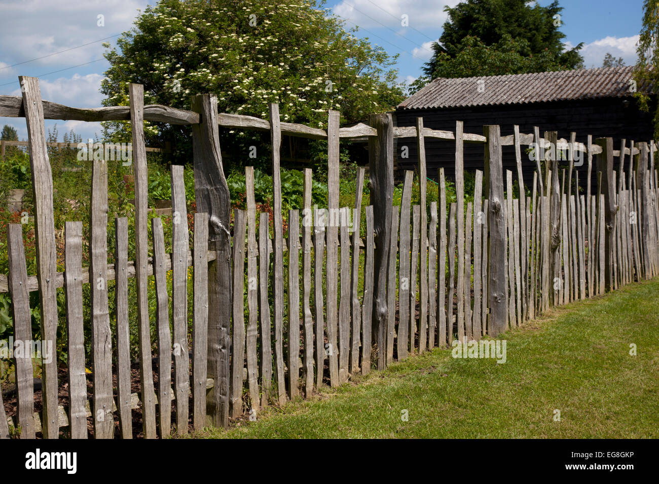 Rustic wooden Cleft fencing in English country garden,Oxfordshire,England Stock Photo