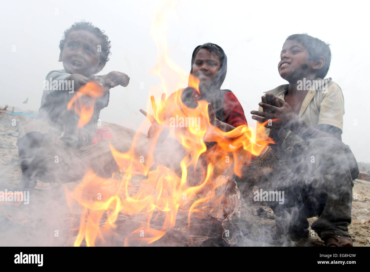 Homeless children create fire by using discarded wood or plastic to provide some warmth as winter temperatures d Stock Photo