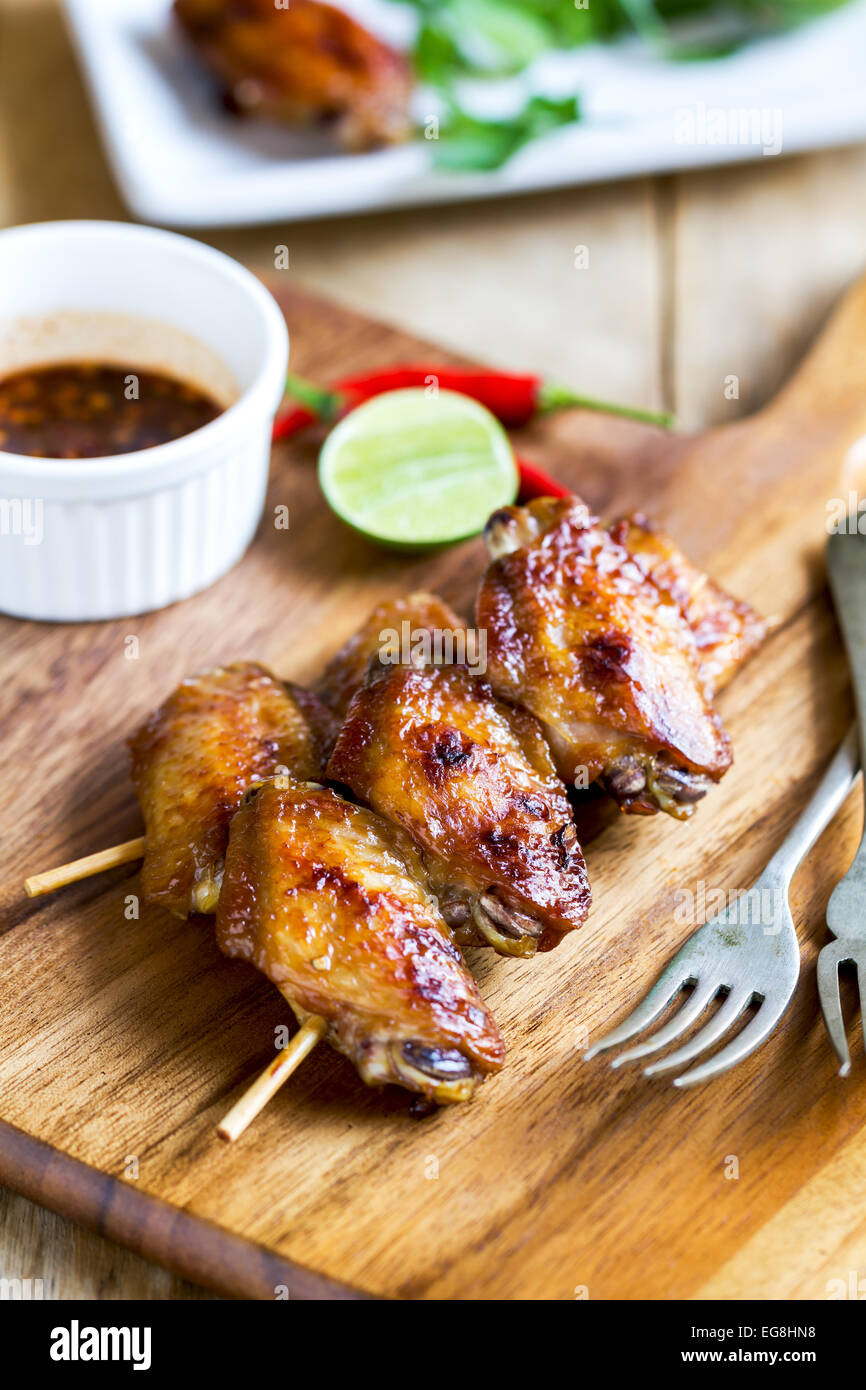 Grilled chicken wings with Thai chili sauce and lime Stock Photo Alamy