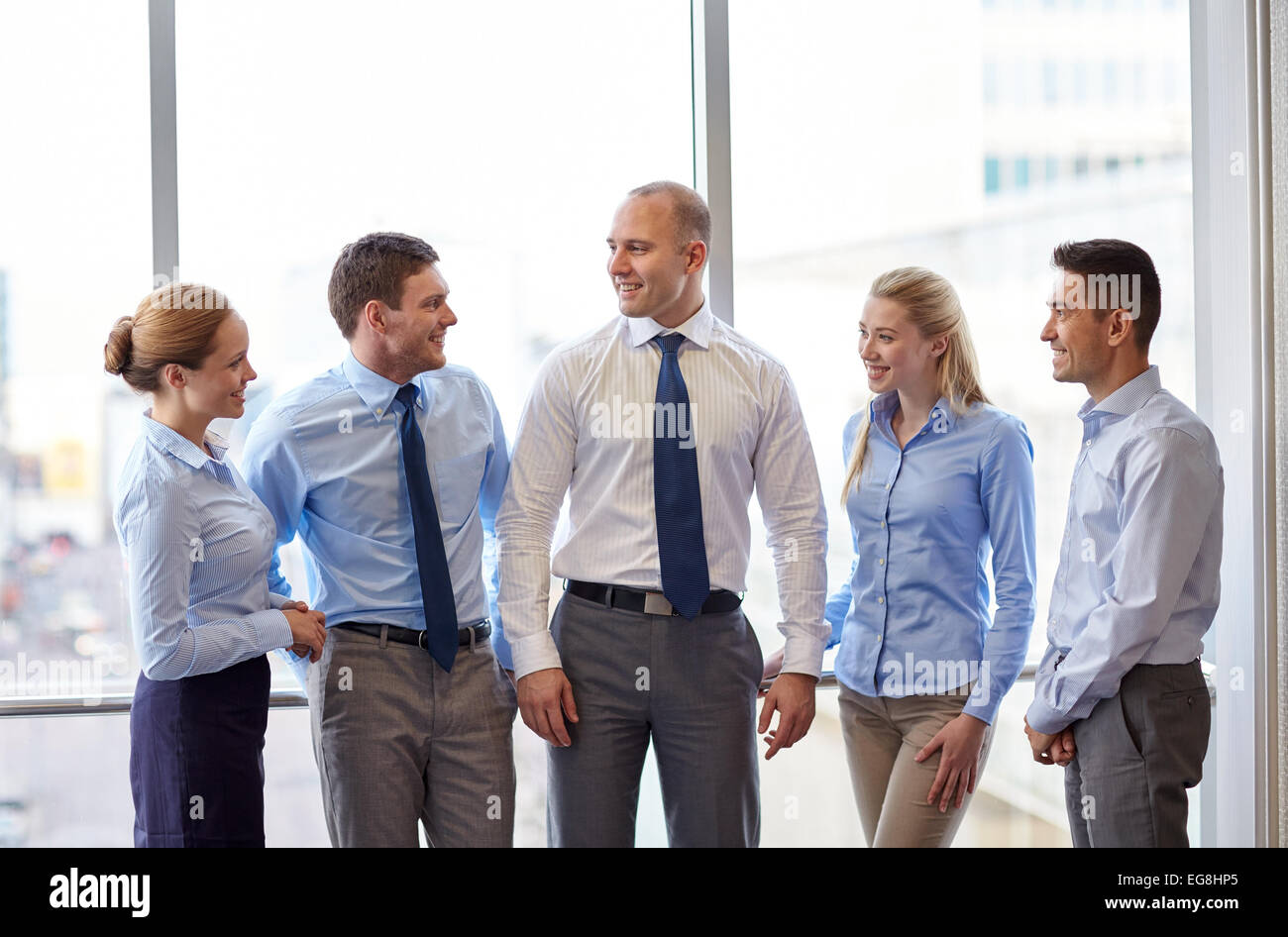 smiling business people talking in office Stock Photo - Alamy