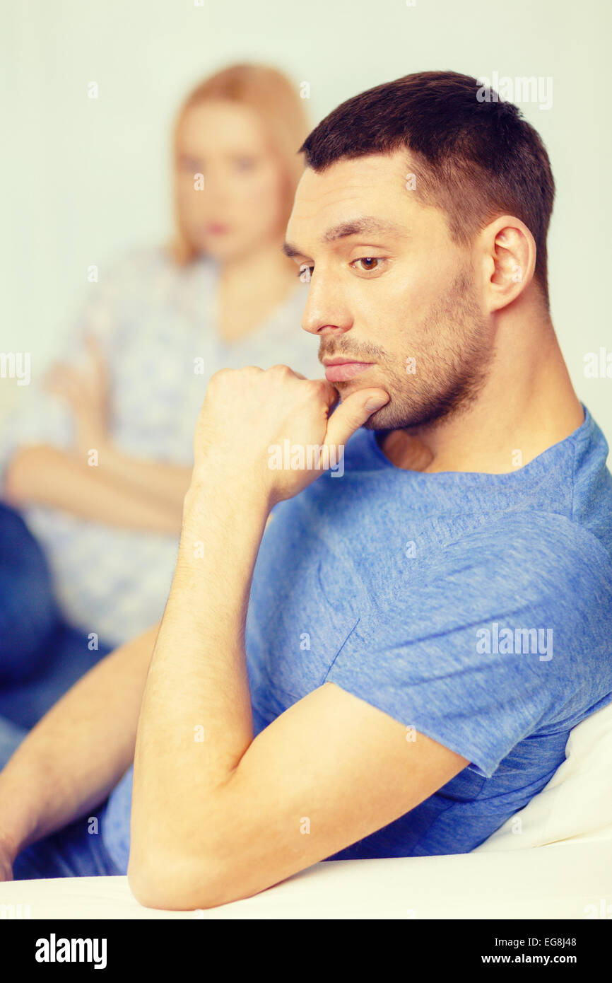 upset young man with man on the back at home Stock Photo