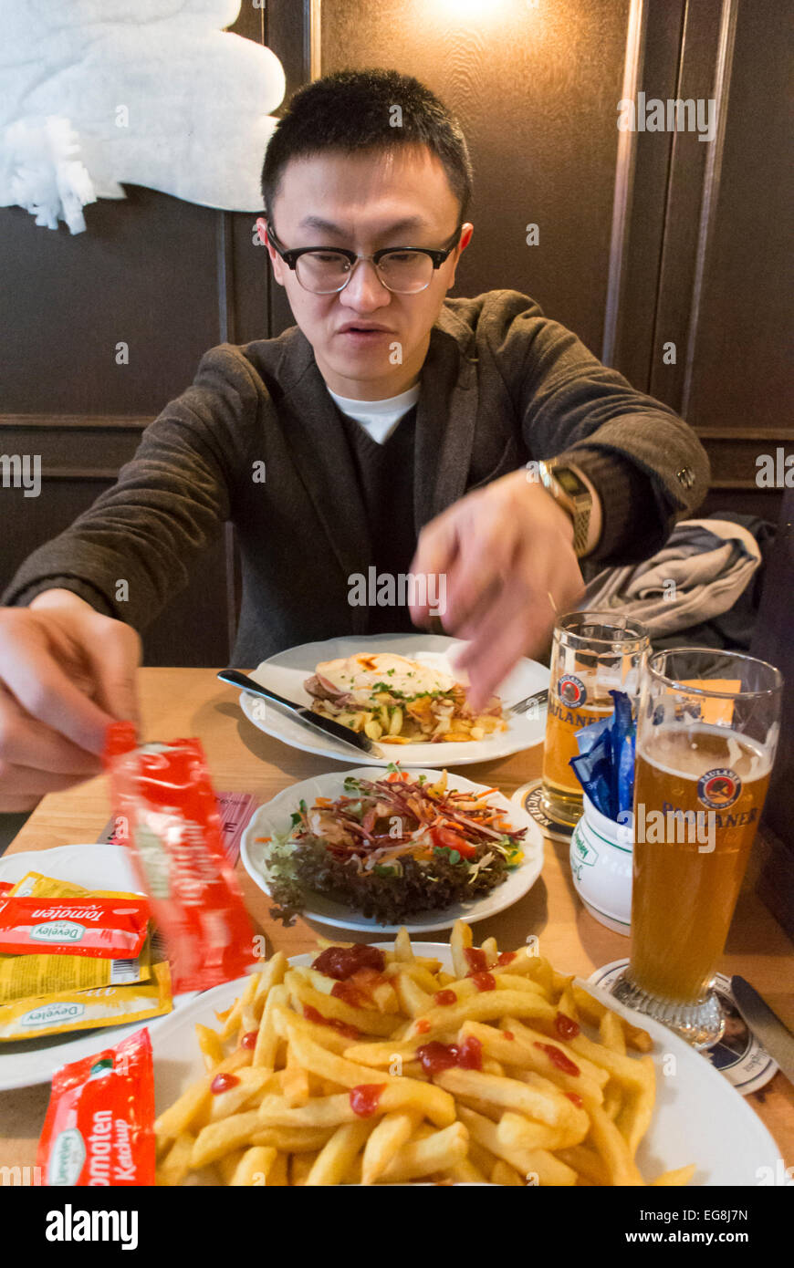 Berlin, Germany, Chinese Tourist Eating Meals inside German Bavarian