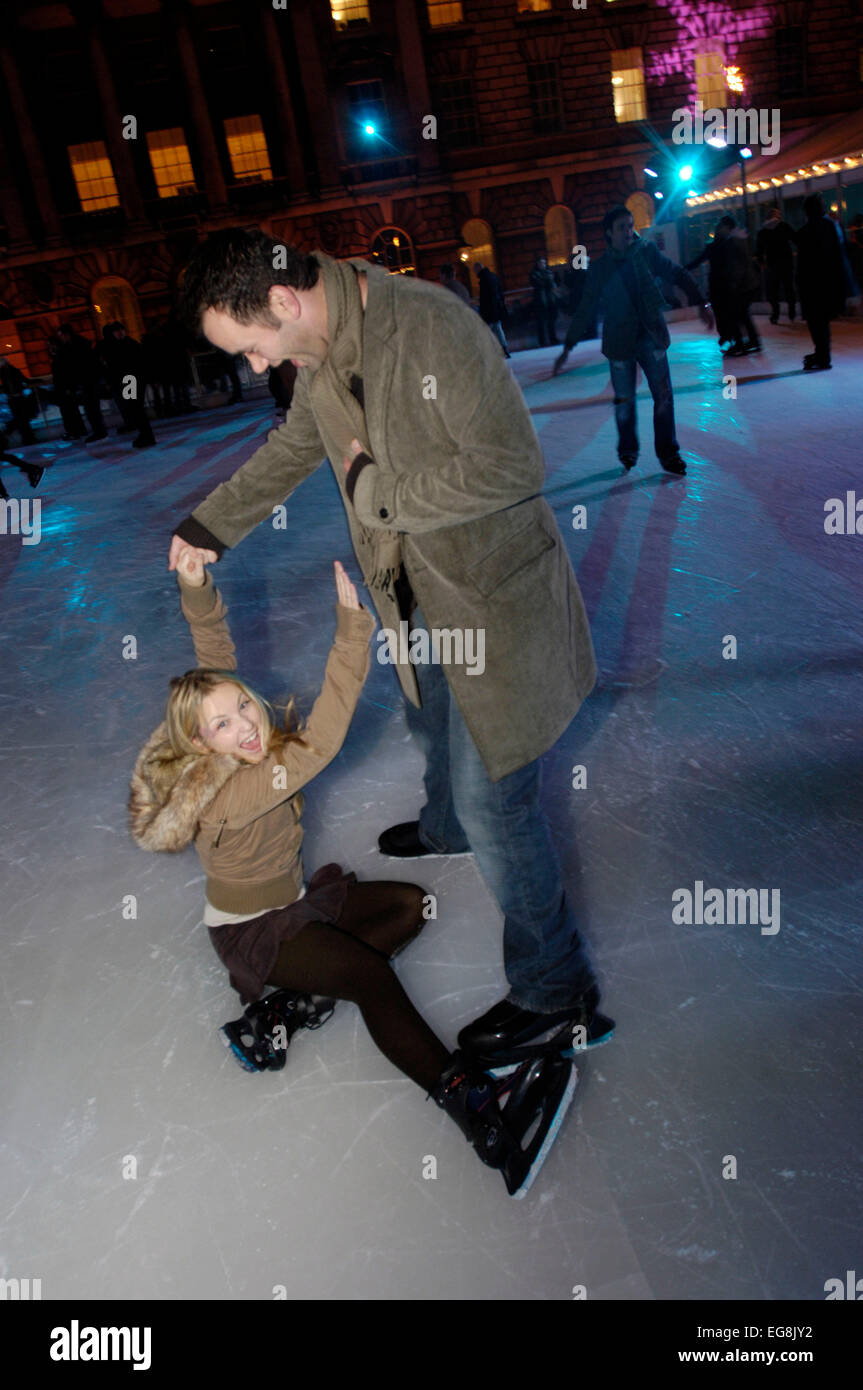 couples skate at Somerset House winter xmas period london UK Stock Photo
