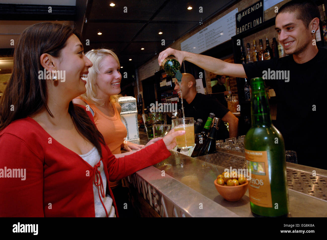A barmen pours a new organic cider the traditional way at recently