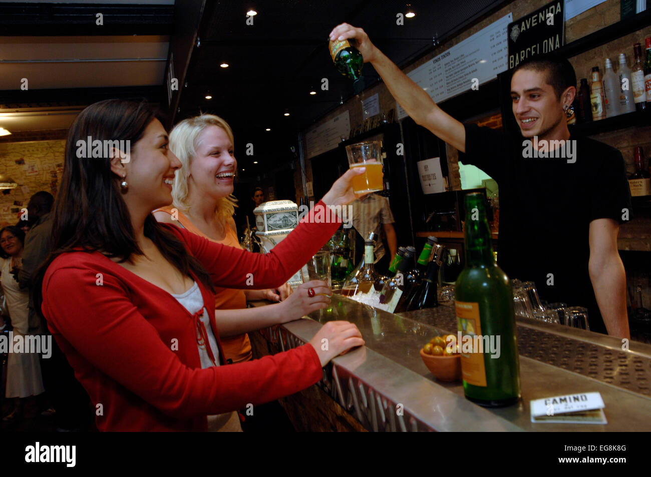 A barmen pours a new organic cider the traditional way at recently