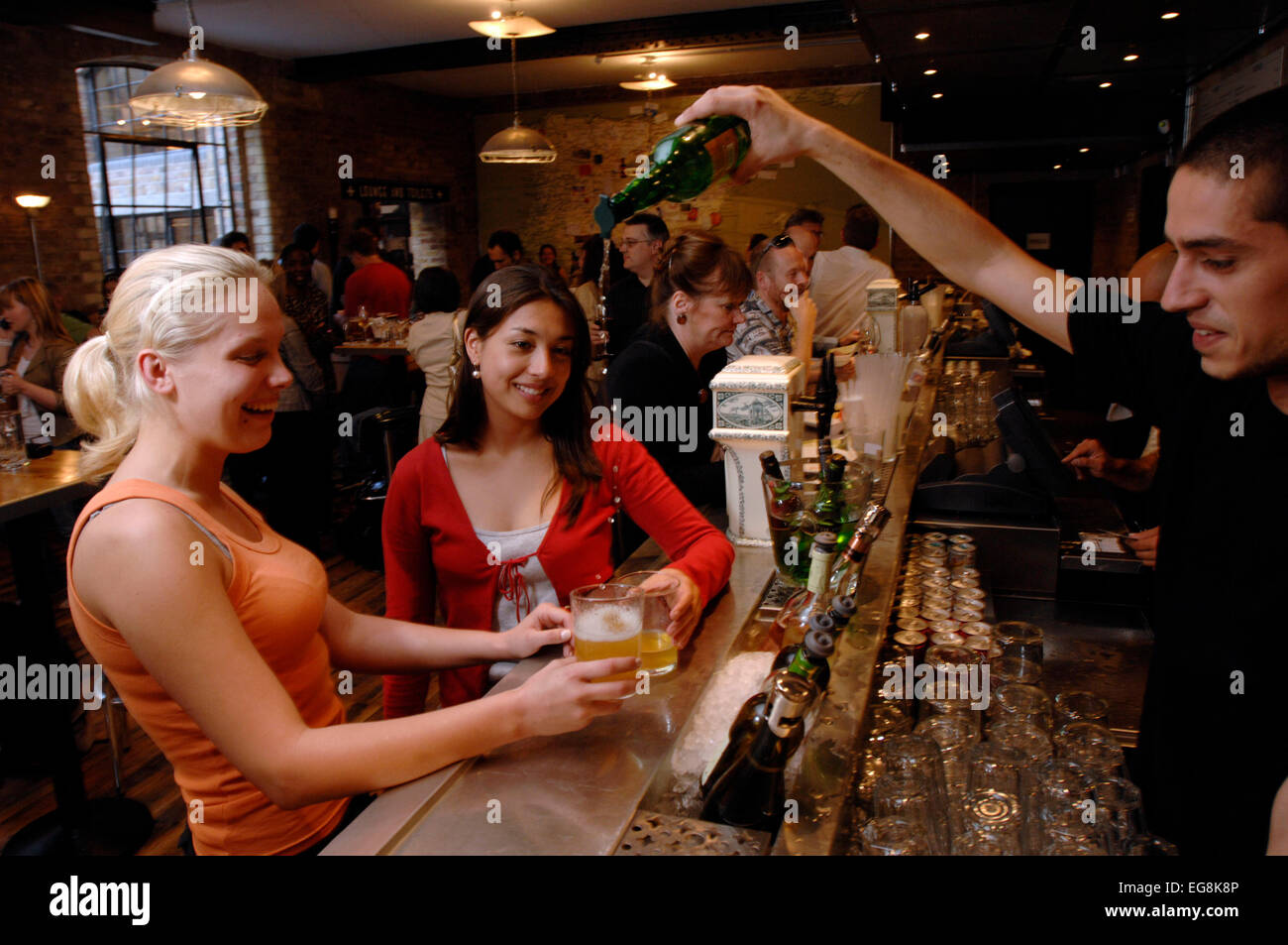 A barmen pours a new organic cider the traditional way at recently