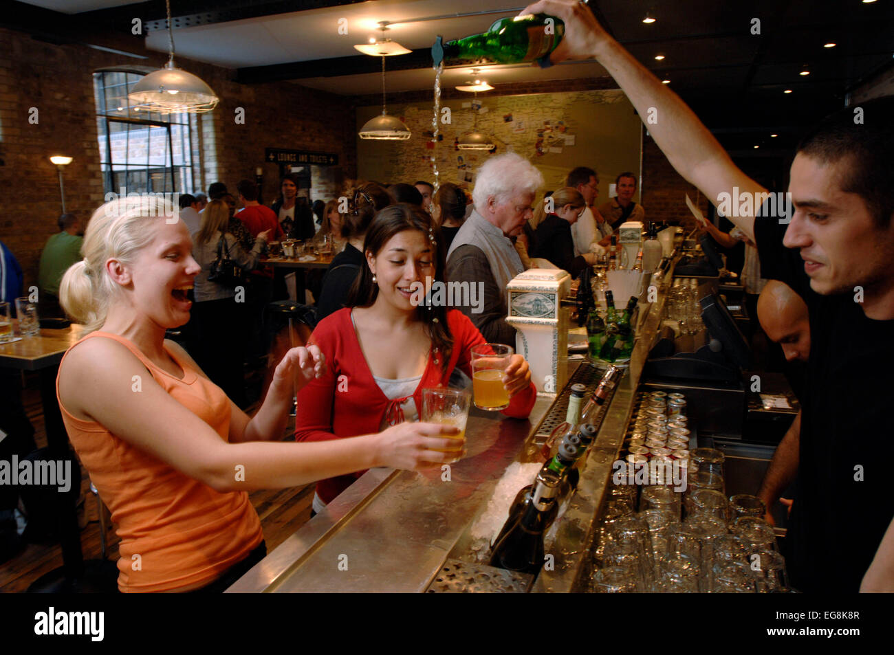 A barmen pours a new organic cider the traditional way at recently