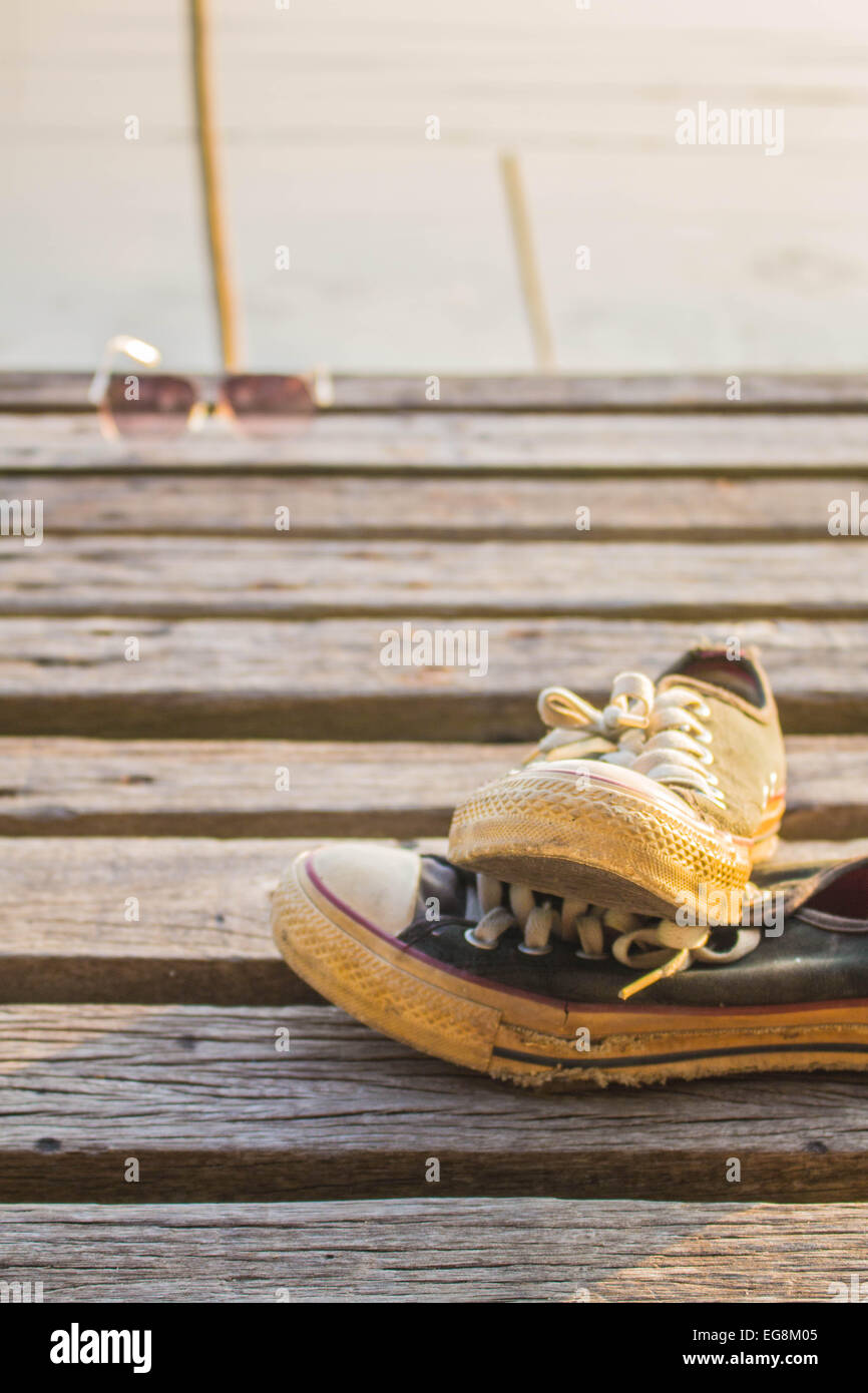 Old sneakers on the wooden floor Stock Photo - Alamy