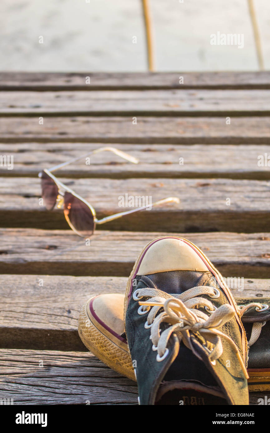 Sneakers are removed on a wooden floor Stock Photo - Alamy
