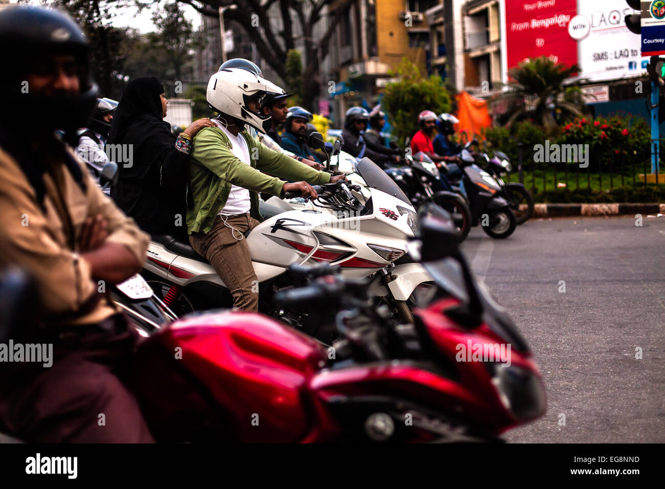 Motorbikes wait at traffic lights in Bangalore Southern India Stock