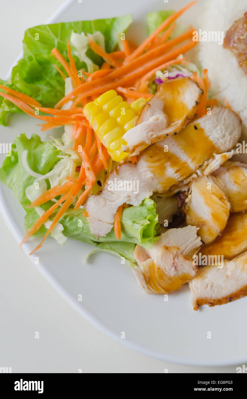 sliced pork tenderloin with fresh salad served with steamed rice Stock Photo