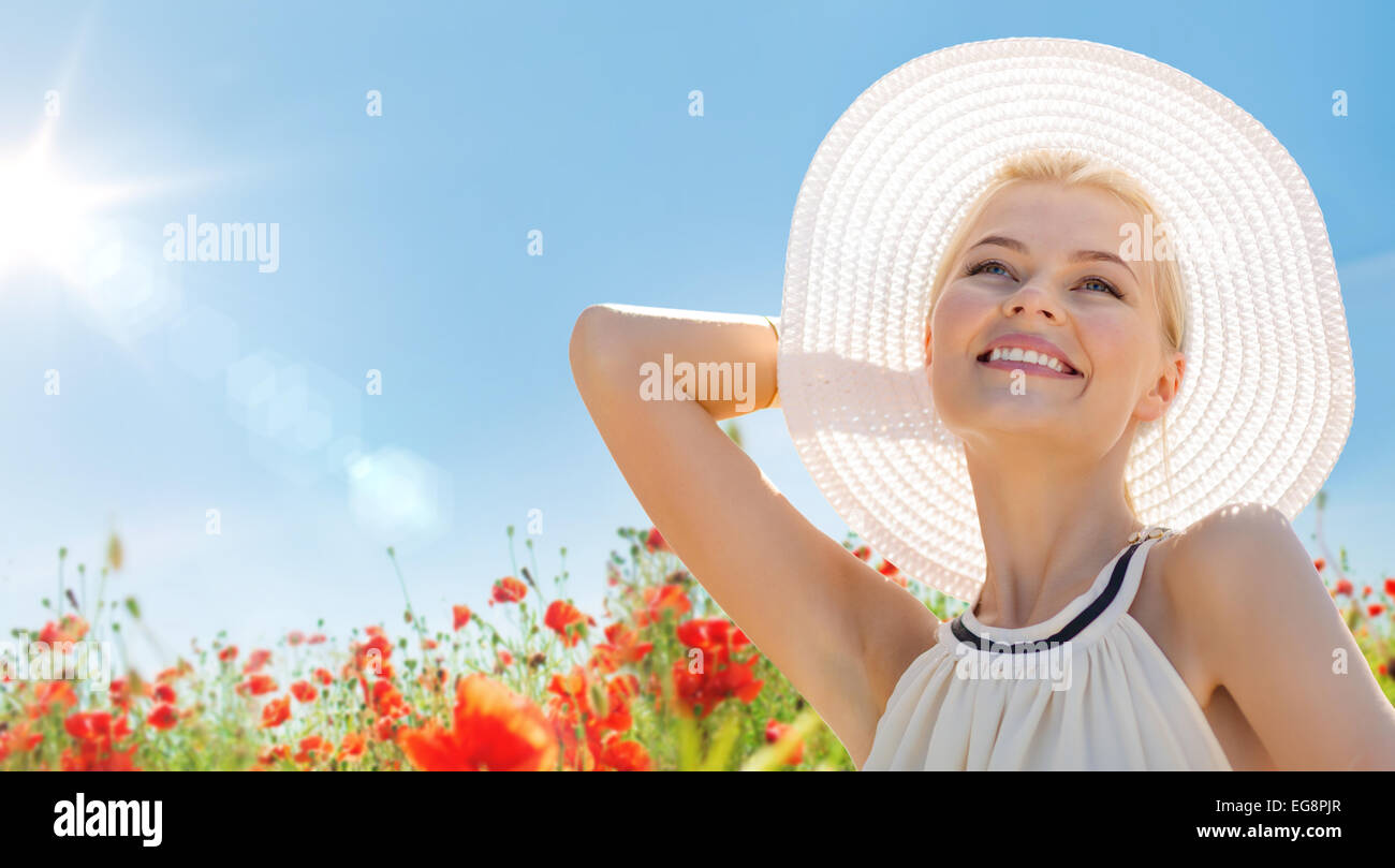 smiling young woman in straw hat on poppy field Stock Photo - Alamy