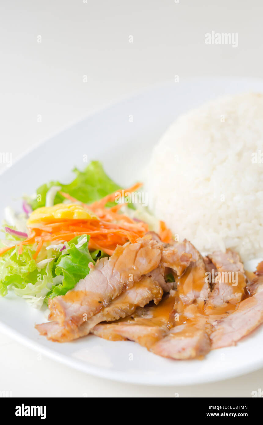 slisliced pork tenderloin with fresh salad served with steamed rice Stock Photo Alamy