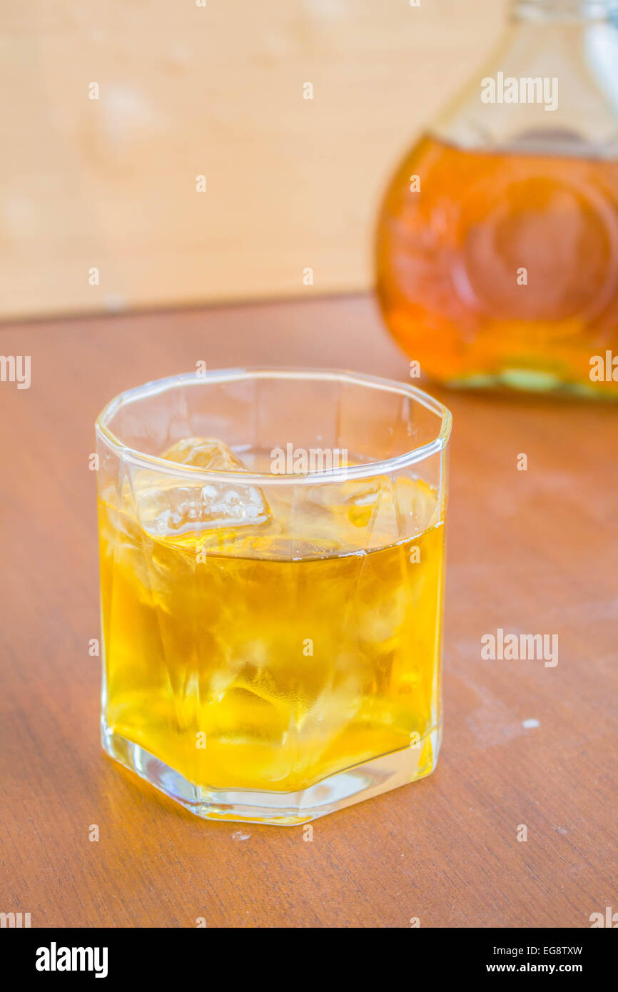 Glass of whiskey on the rocks on the table Stock Photo - Alamy