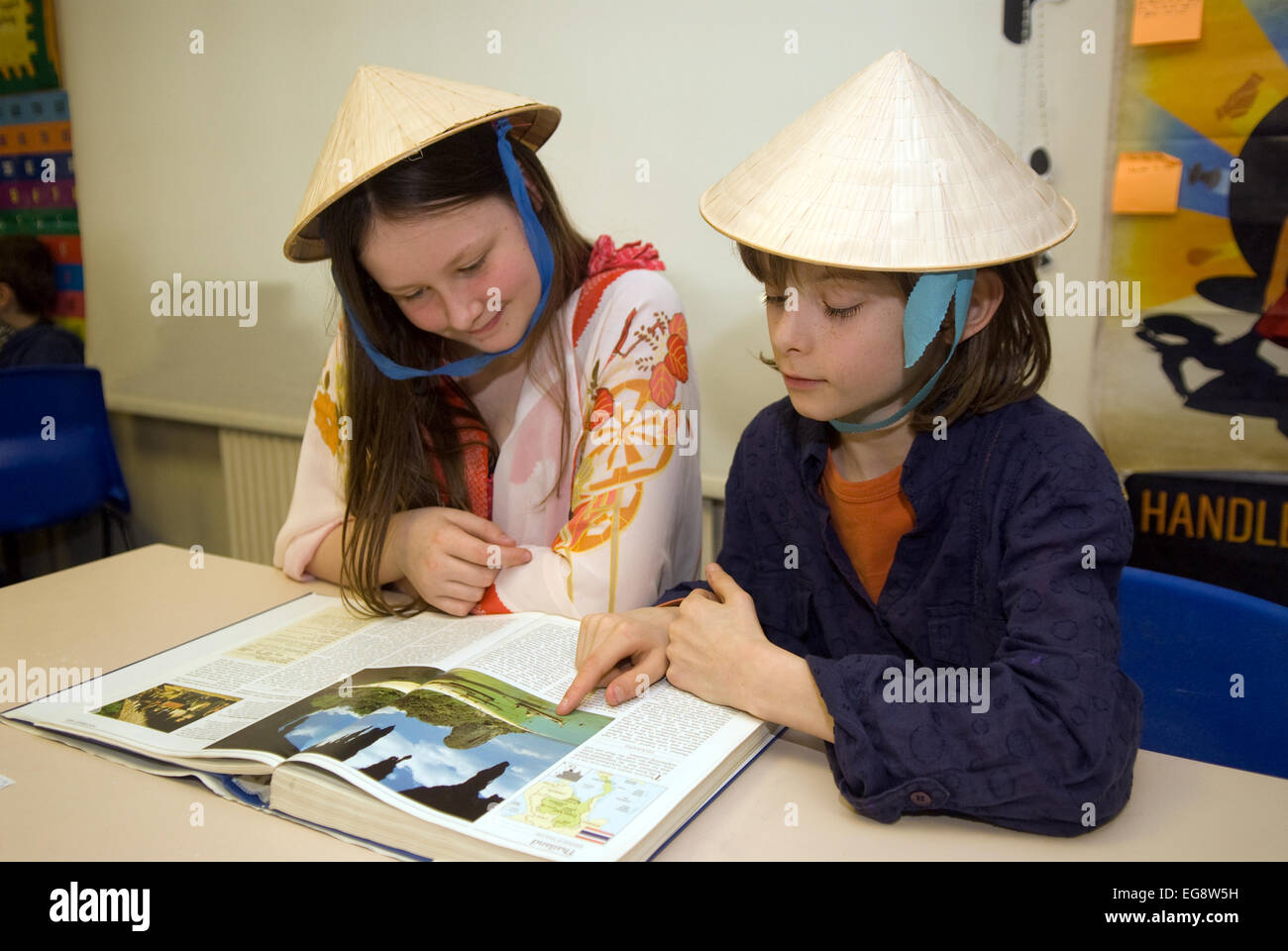 Pupils in costume in class studying Thailand as part of World Day, Surrey, UK. Stock Photo