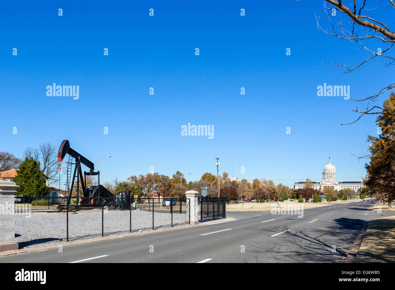 Oil well on N Lincoln Blvd with the Oklahoma State Capitol in the distance, Oklahoma City, OK, USA Stock Photo