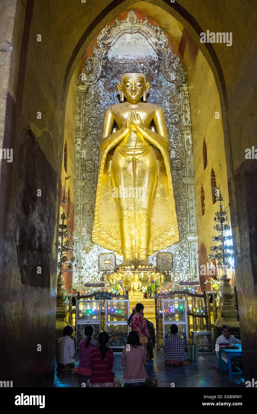 Huge gold standing Buddha,one of four huge statues facing cardinal directions,Ananda Buddhist temple Pagan,Bagan,Burma,Myanmar Stock Photo