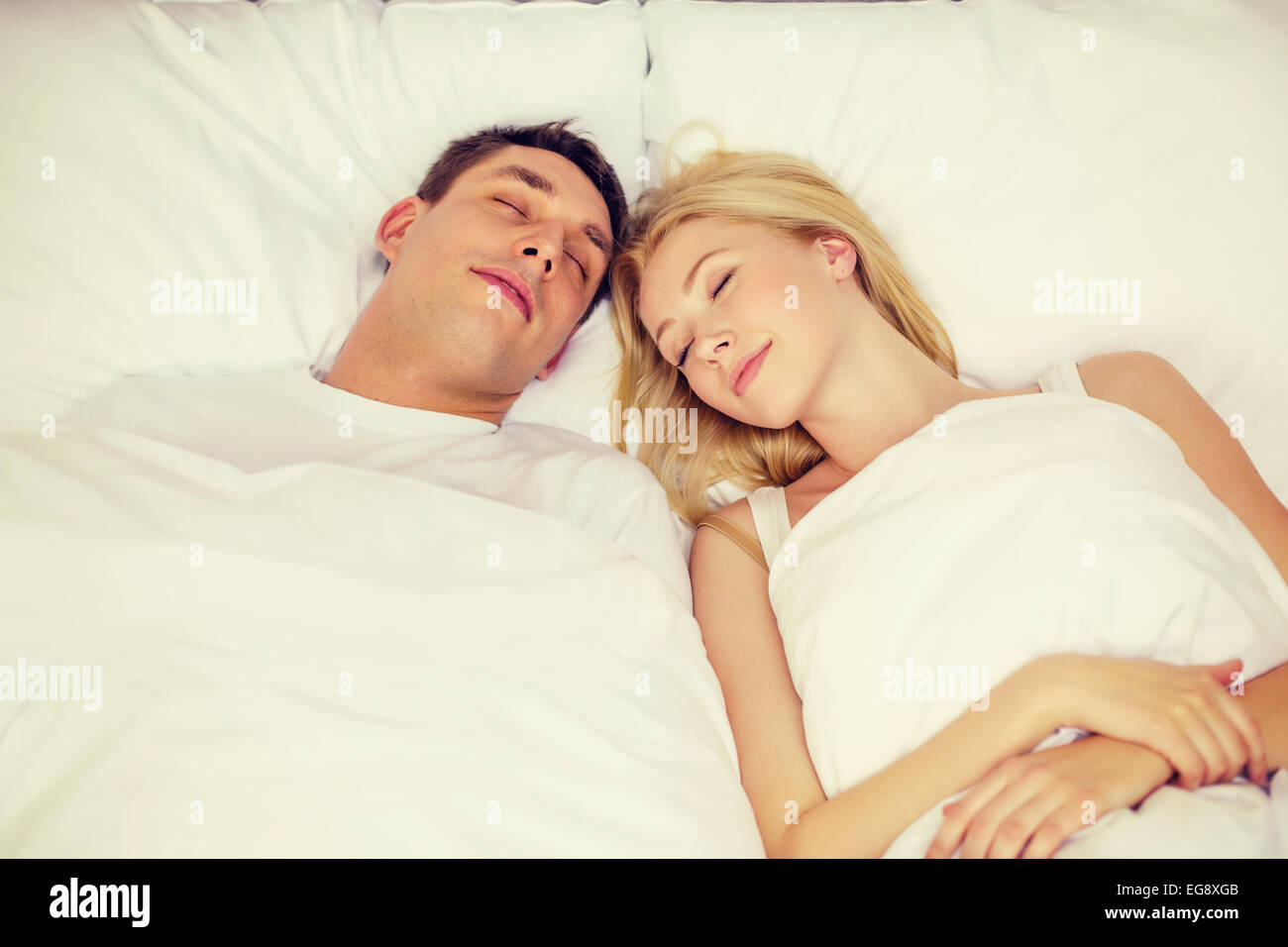 happy couple sleeping in bed Stock Photo - Alamy