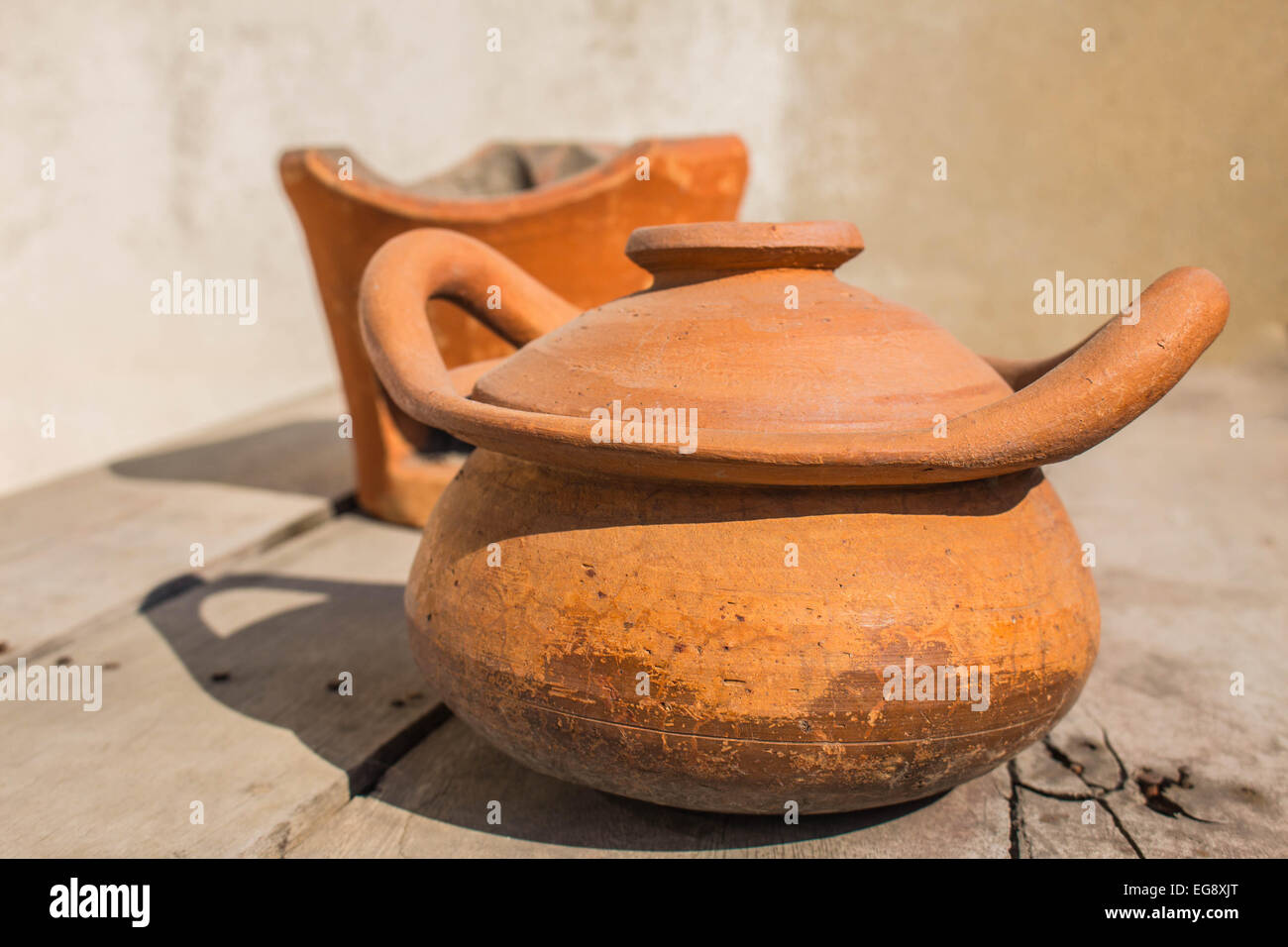 Clay pot on a wooden floor Stock Photo
