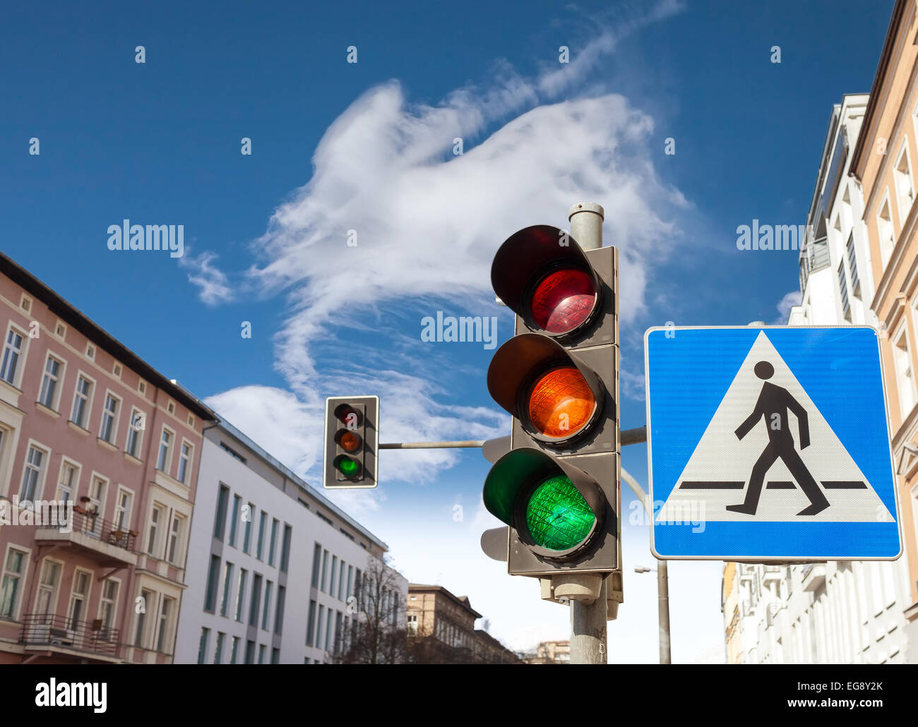 Traffic lights and pedestrian crossing sign in a city. Stock Photo