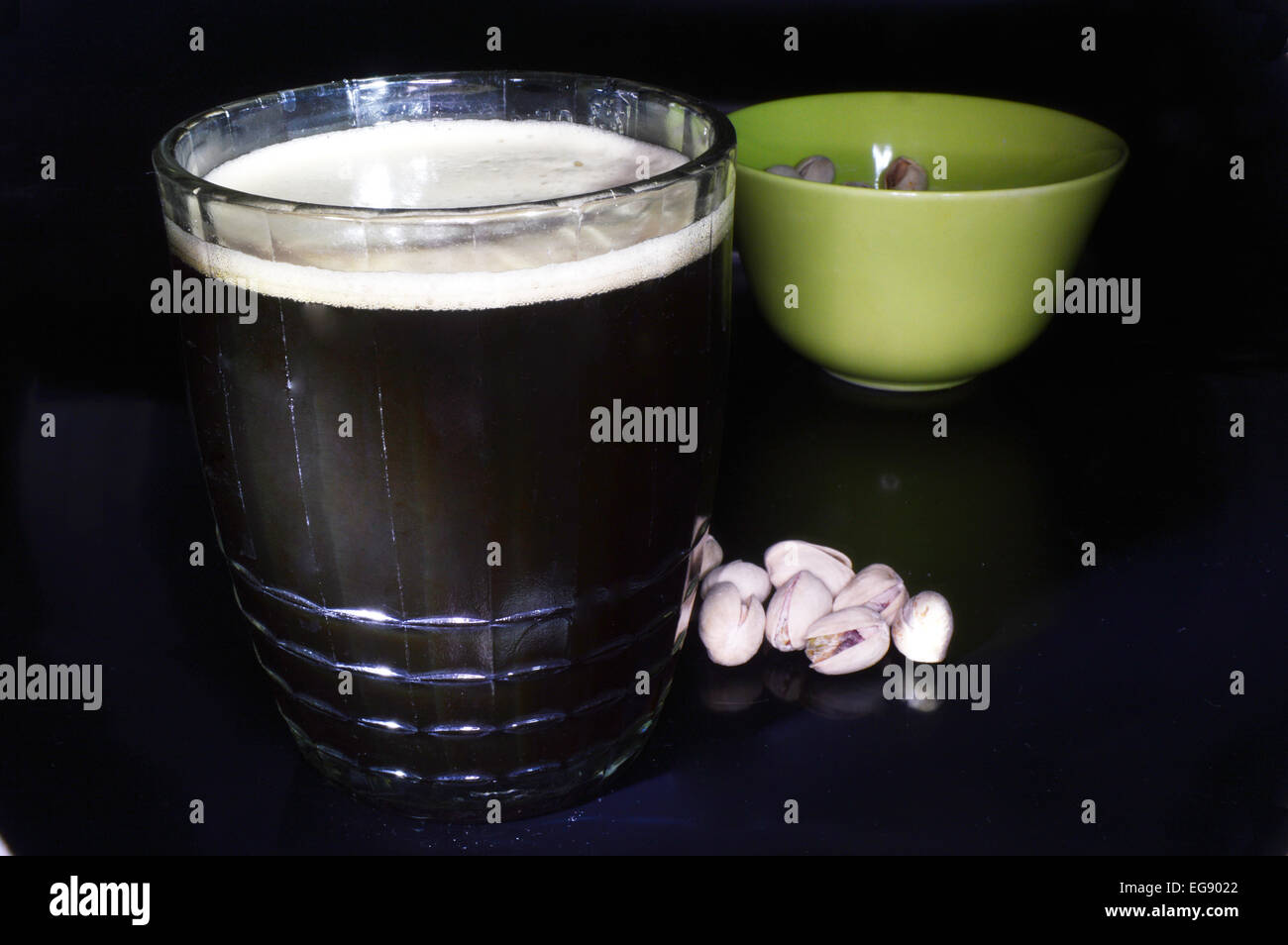 Dark beer and pistachios on a black background Stock Photo