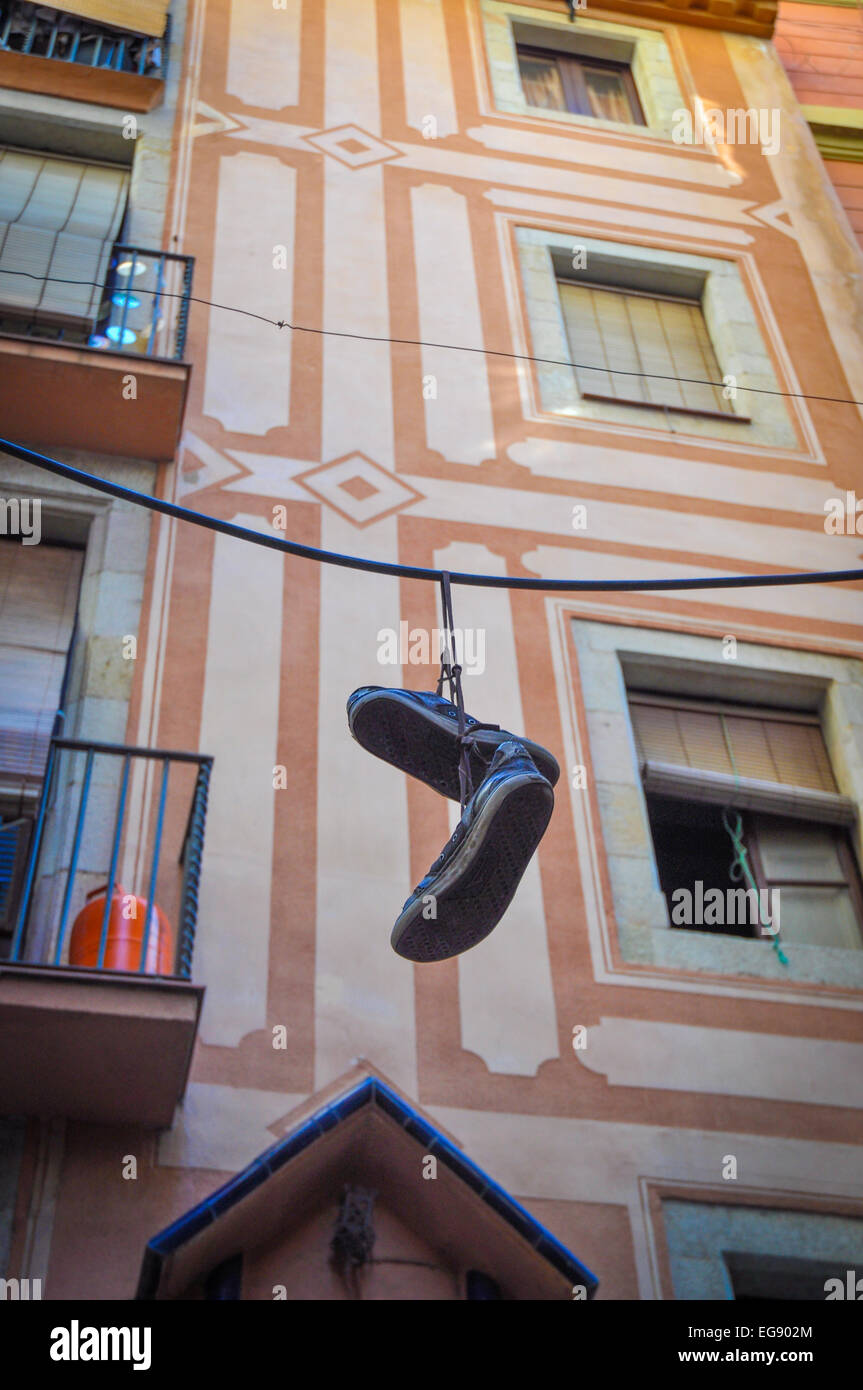 Barcelona Spain shoes hanging from wire old Gothic quarter Stock Photo
