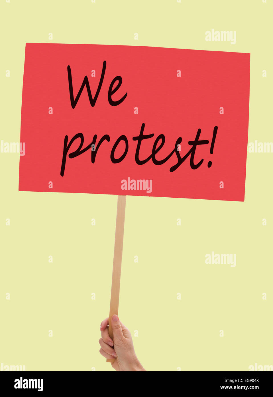 Fairly generic protest placard over pale yellow. Stock Photo