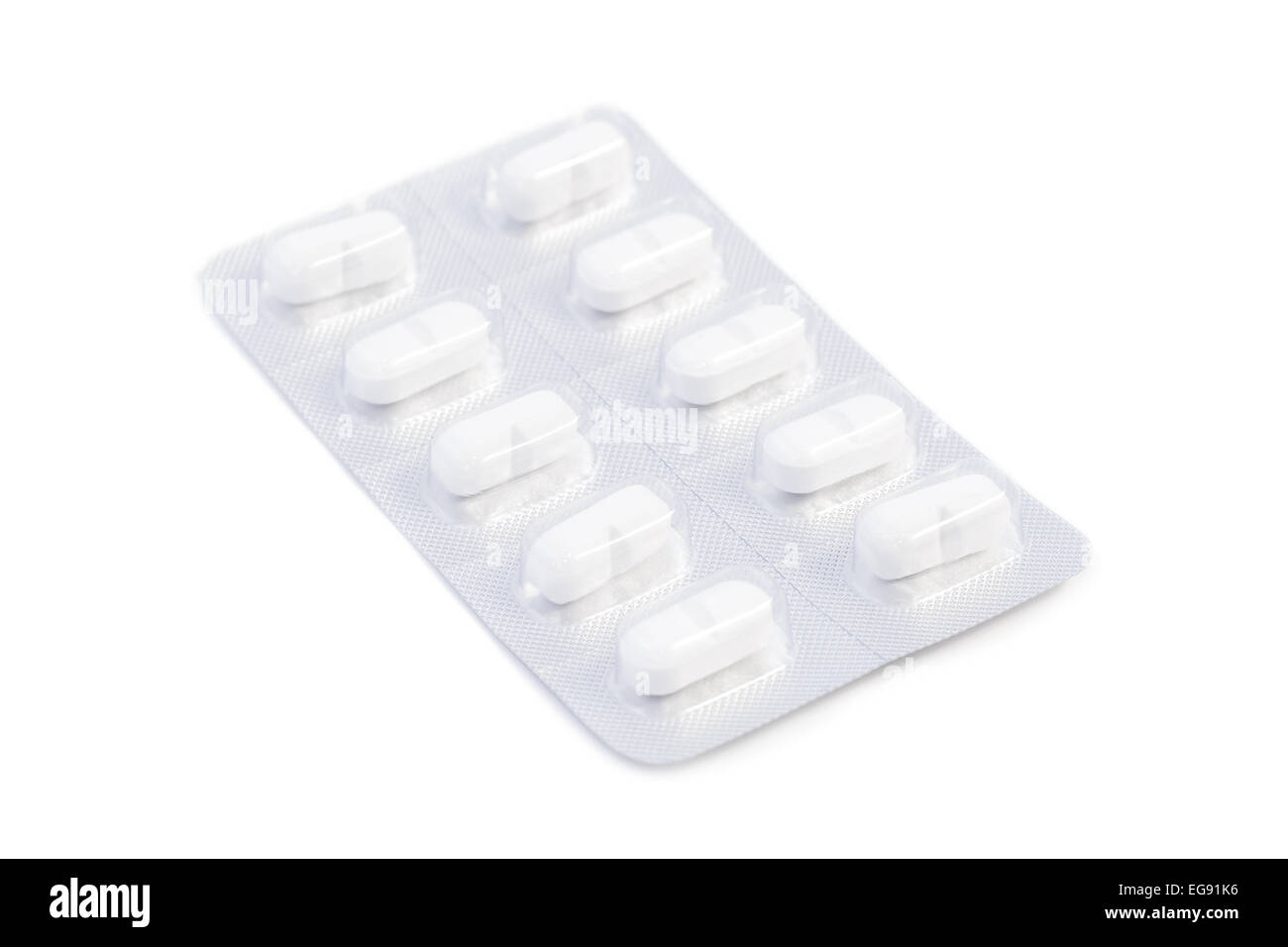 Closeup of white medicine pills in an unused blister pack, isolated on white background Stock Photo