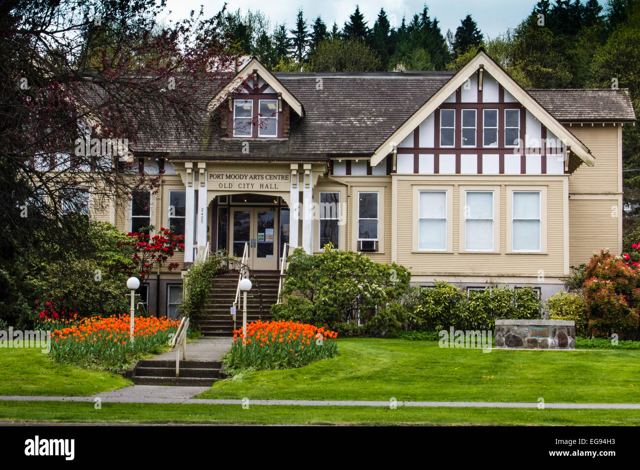 Historic Port Moody Arts Centre Building on a beautiful spring day with gardens of tulips blooming. Stock Photo